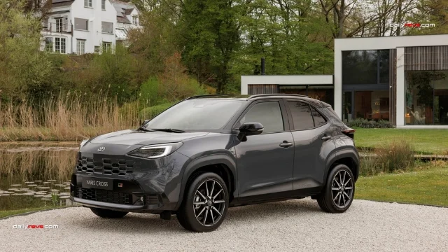 2027 Toyota Yaris Cross GR Sport – Grey Exterior Front Three-Quarter View 2027 Toyota Yaris Cross GR Sport in dark grey, showing its honeycomb front grille, LED headlights, GR Sport badge, black exterior trim and multi-spoke alloy wheels.
